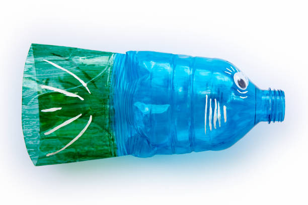 istock Plastic bottle recycled in a fish figure. Reuse garbage 1084455750
