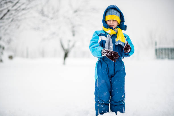 istock Little boy enjoying snow after heavy snowfall 1084455948