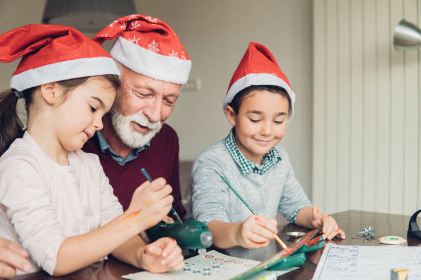 istock Family in Santa hats making a toy 1084455984