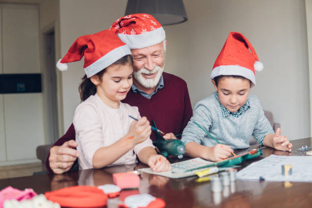 istock Happy man looking at children making a toy 1084456070