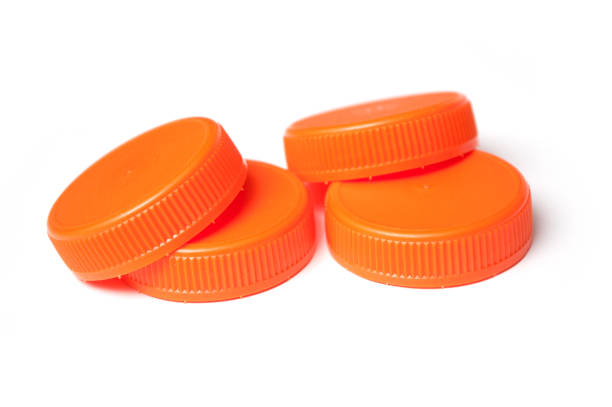 istock orange plastic plugs for recycling on white background 1084456706