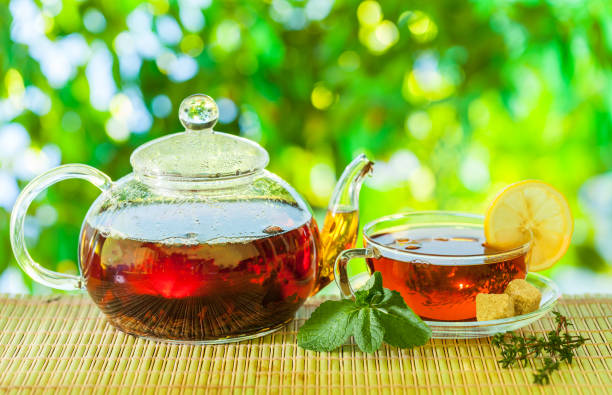 istock Tea time. Pouring out hot tea into a cup. 1084458570