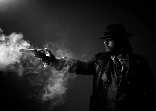 Caucasian Male in vintage trench coat and fedora. Black and white