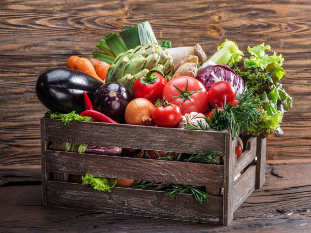istock Fresh multi-colored vegetables in wooden crate. 1084461198