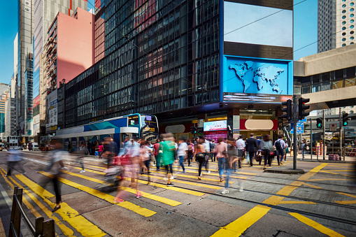 Commuter at crosswalk in financial district at Hong Kong.