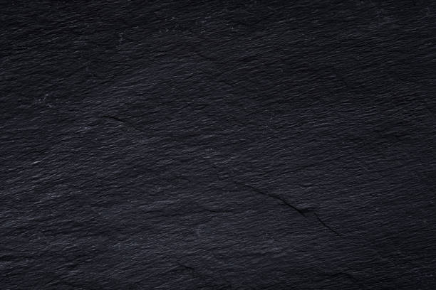 istock Dark gray black slate background or texture of natural stone. 1084464438