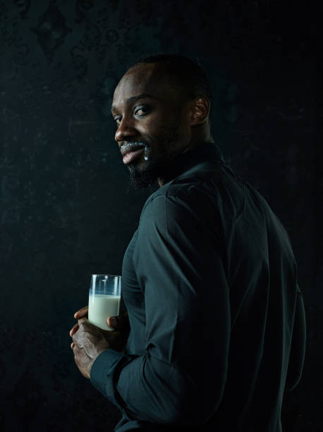 istock Healthy young african man holging milk 1084464562