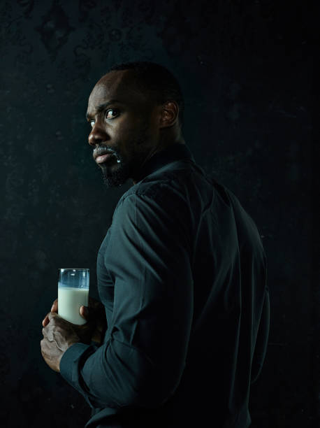 istock Healthy young african man holging milk 1084464566