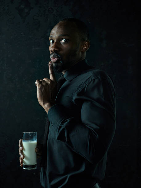 istock Healthy young african man holging milk 1084464576