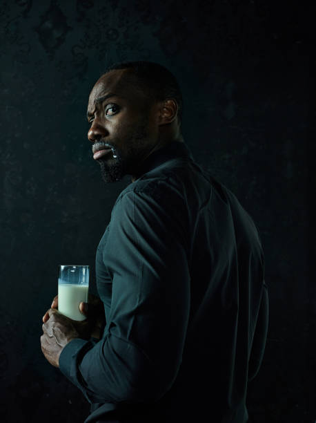 istock Healthy young african man holging milk 1084464600