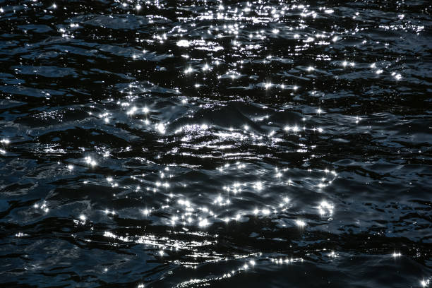 istock Surface of the water, waves with sun highlights, bright reflections. 1084466880