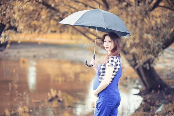 istock Young girl in autumn park 1084468410