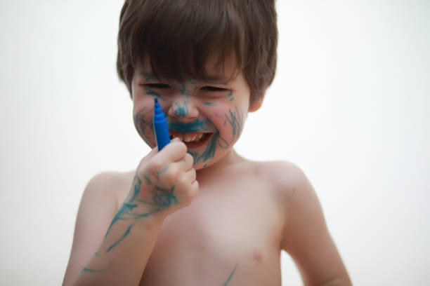 istock A child painted his face with colors 1084471620