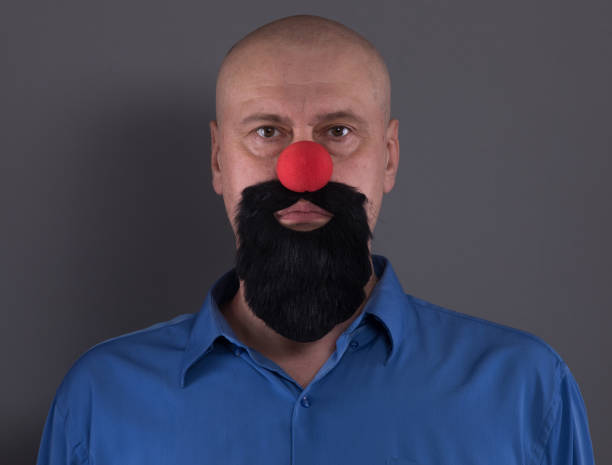 istock bearded funny man with a red nose 1084472922