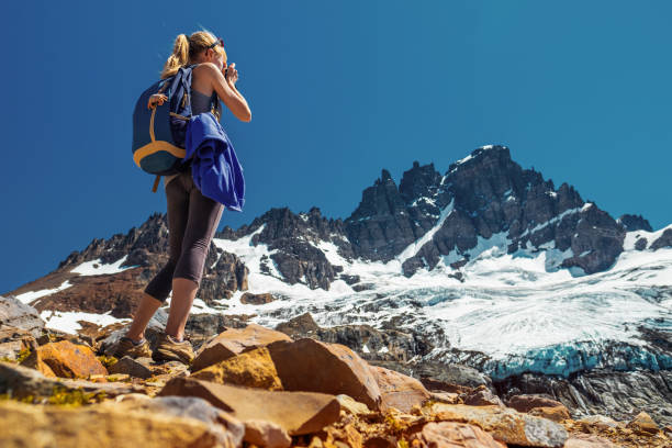 Hiker Amateur photographer and hiker takes picture of the mountain with glacier. Cerro Castillo Mountain, Chile chile tourist stock pictures, royalty-free photos & images