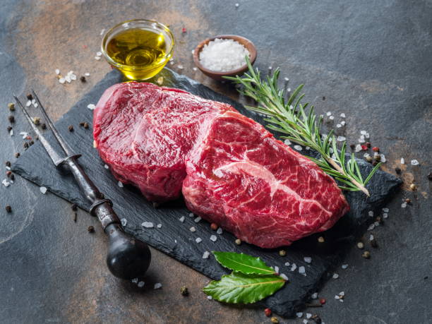 istock Raw  Rib eye steak or beef steak with herbs and spices. 1084477186