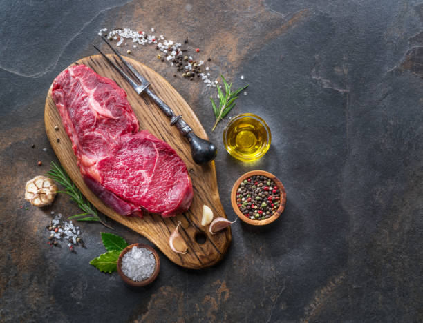 istock Raw  Rib eye steak or beef steak with herbs and spices. 1084477266
