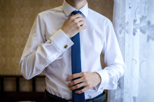istock The man straightens his tie closeup 1084477522