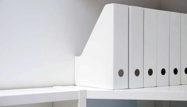 istock Office folders for documents. A folder with files on the sideboard in a bright modern office, archive and documents 1084478762