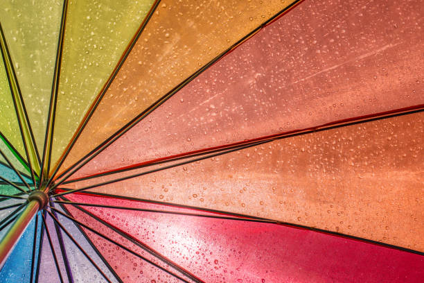 colorful wet umbrella in the sunlight - rainbow umbrella descriptive color multi colored imagens e fotografias de stock