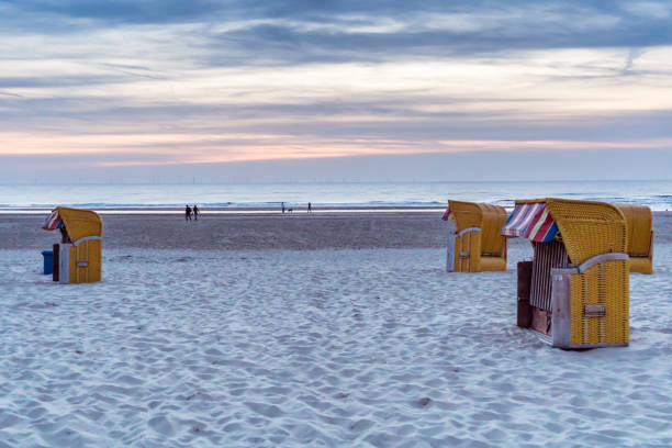 istock Yellow beach chair cabins on an evening beach 1084479284