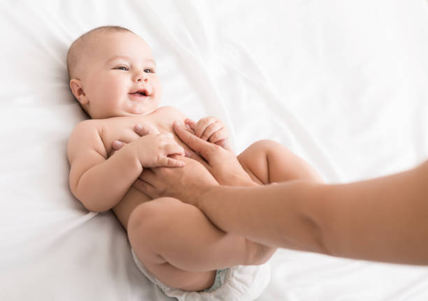 istock Professional masseur doing massage to newborn baby 1084486350
