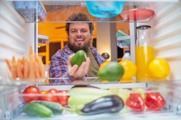 istock Man looking for something to eat at night. 1084487582