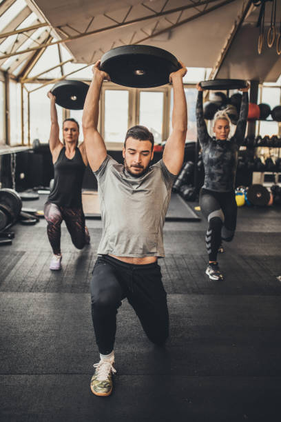 istock Lunge training with personal trainer in gym 1084490300