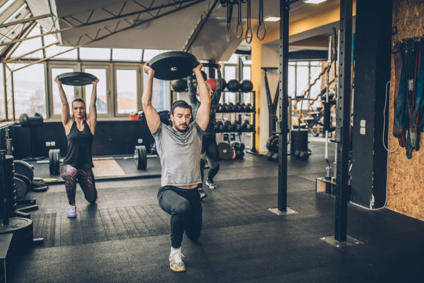 istock Girl training together with personal trainer in gym 1084490342