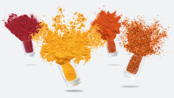 istock Glass jars with various spices flying on white background 1084497602