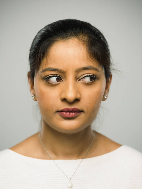 istock Real indian young woman with blank expression looking to the side 1084498224