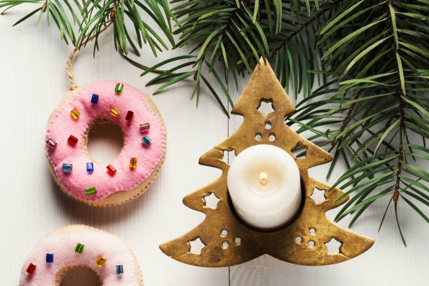 istock Christmas tree candlestick, burning candle and donuts decorations 1084501218