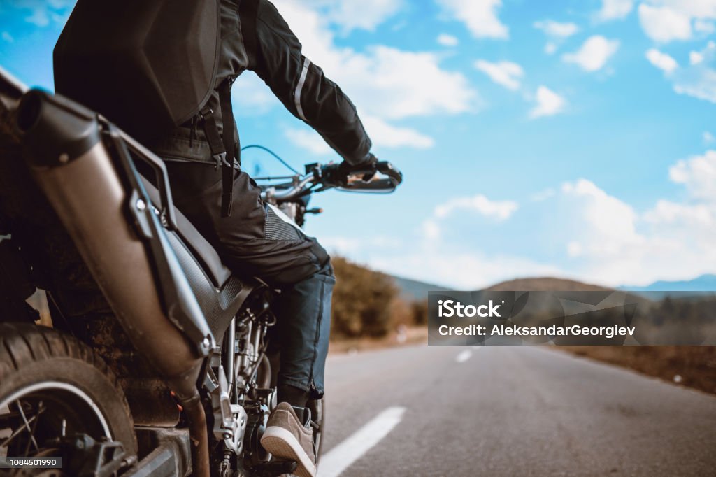 Alone On The Road Motorcyclist with Specialized Protection Equipment Motorcycle Stock Photo