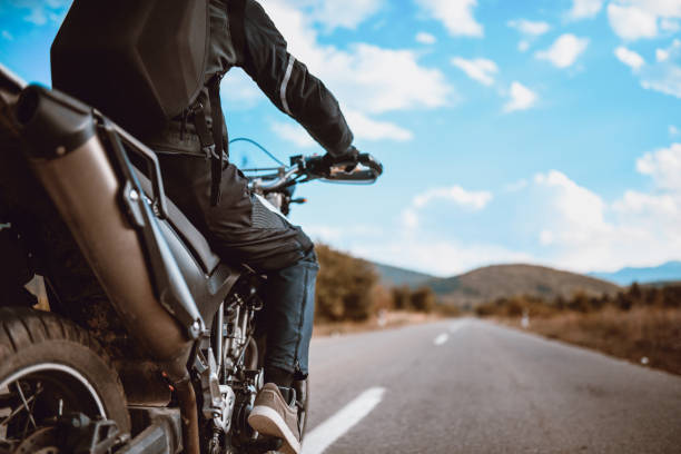 Alone On The Road Motorcyclist with Specialized Protection Equipment biker stock pictures, royalty-free photos & images