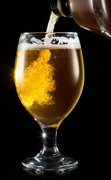 istock Filling a mug with a beer on white background. 1084504094