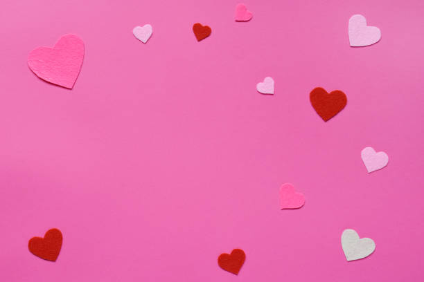 istock Felt hearts on pink background. St. Valentine's Day concept. Top view, flat lay. Copy space 1084505462