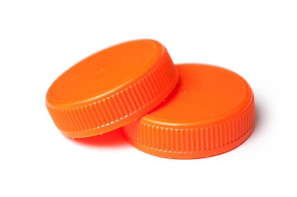istock orange plastic plugs for recycling on white background 1084508490