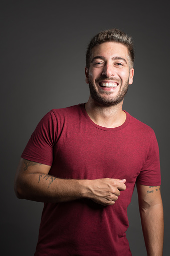 Studio Portrait: young man smiling and looking at camera