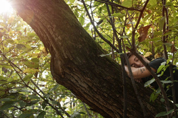 istock Portrait Set: young man in the woods resting on a tree 1084508886