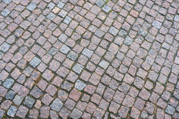 istock Ancient granite paving. Close-up view from above. Pavement. 1084515522