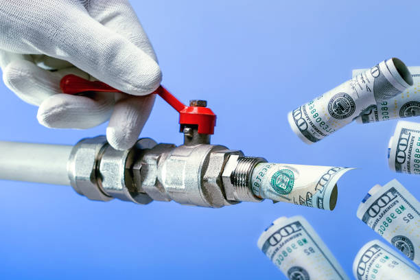 istock Hand opens the tap with money.  money flows. 1084516690