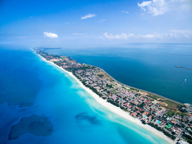 Bird's-eye view to island in summer sunny day VARADERO, CUBA – MAY 25, 2016: Dron flies over tropical island on a clear day. Calm Atlantic Ocean and the bay. It is flying over the city. Height of 500 meters. cuba photos stock pictures, royalty-free photos & images