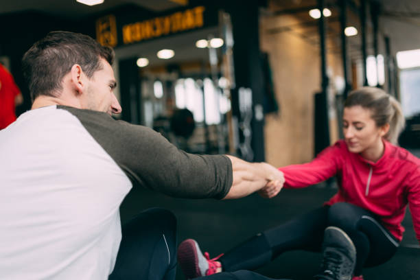 istock Couple doing pistols squat together and having fun 1084518842