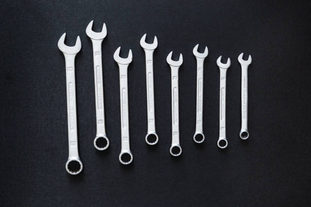 istock Wrench craftsman tool on black background, top view, flat lay 1084526044