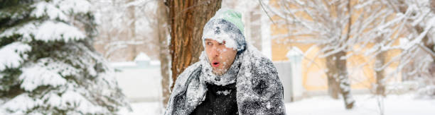close up portrait of frost man face covered by snowy scarf and hat outdoor, winter concept f close up portrait of frost man face covered by snowy scarf and hat outdoor, winter concept frost face stock pictures, royalty-free photos & images