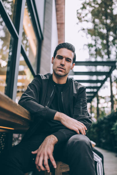 istock Serious young man sitting and looking at camera 1084530474