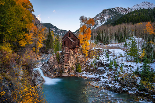 Historic wooden powerhouse called the Crystal Mill in Colorado with colorful autumn colors. It is located on an outcrop above the Crystal River in Crystal ghost town and was built in 1892.