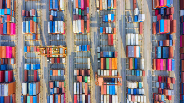 istock Container ship in export and import business logistics and transportation. Cargo and container box shipping to harbor by crane. Water transport International. Aerial view and top view. 1084535854