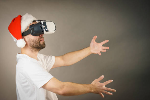 istock Man in virtual reality goggles and santa hat 1084540344
