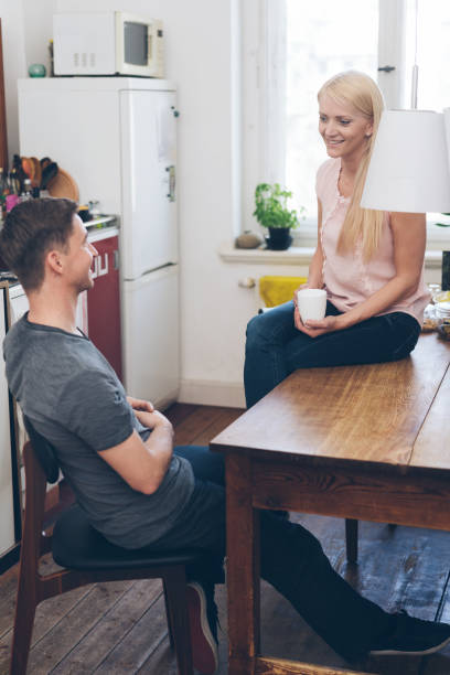 istock Young couple relaxing indoors at home chatting 1084540370